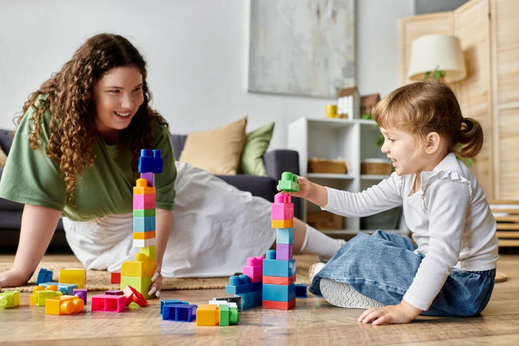 A woman looking at a child while playing with her.