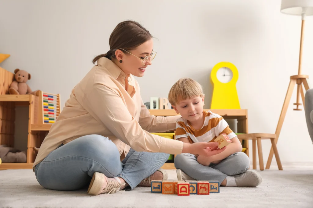 A Nanny playing with child in a private household