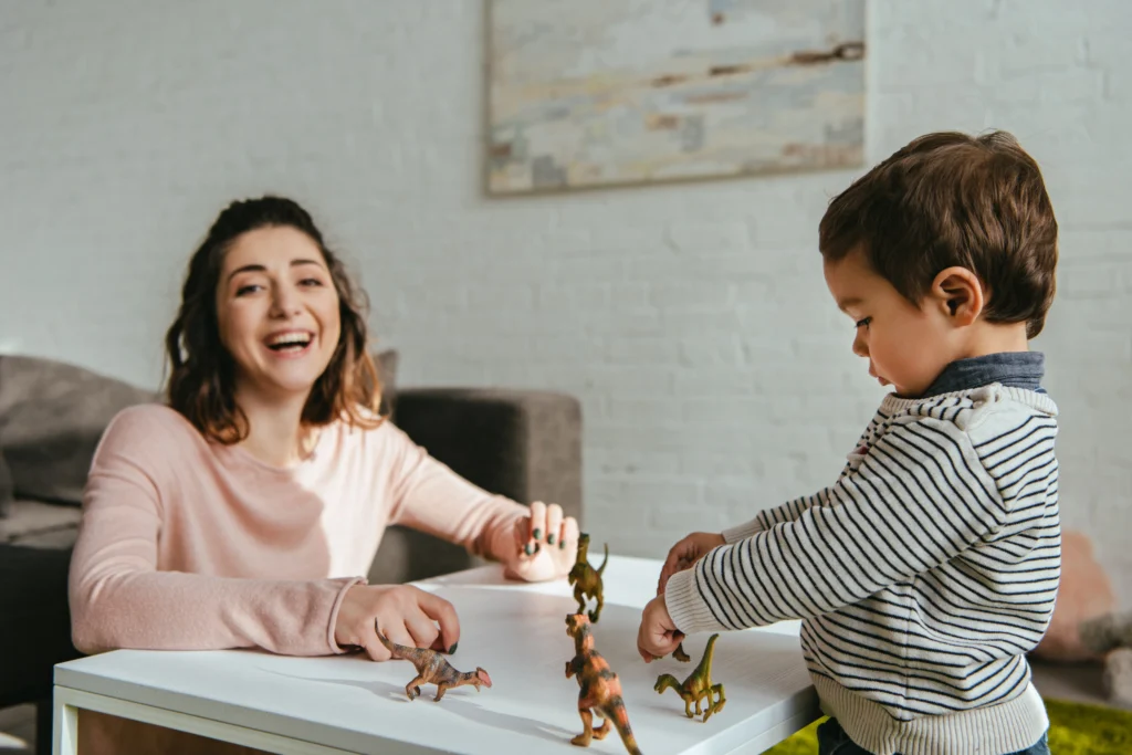 A certified nanny professional playing with a child.