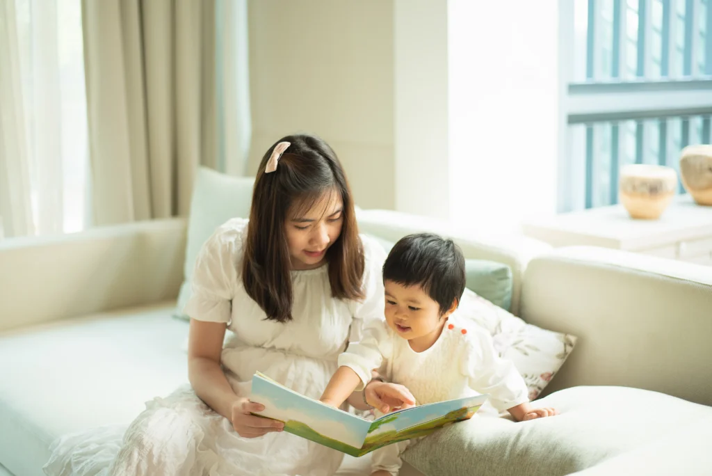 A certified nanny professional reading a storybook for a child. 