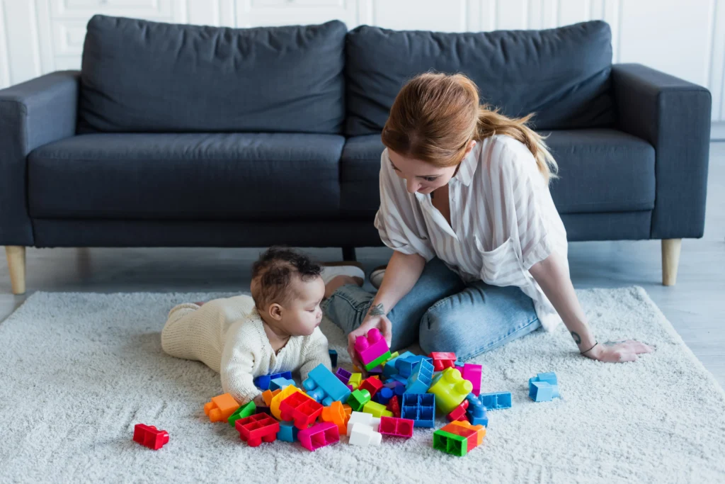A Babysitter Playing with a child.