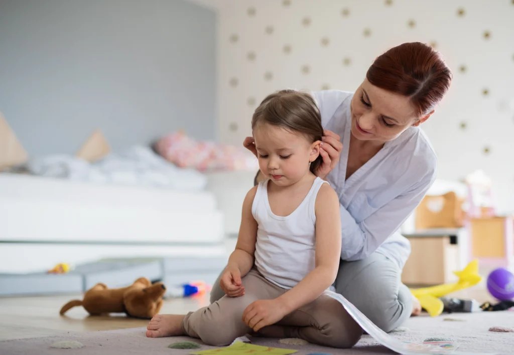 Professional nanny caring for a young child at home, showing the trusted support provided by a nanny service